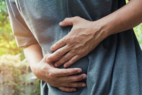 image of a man holding his stomach